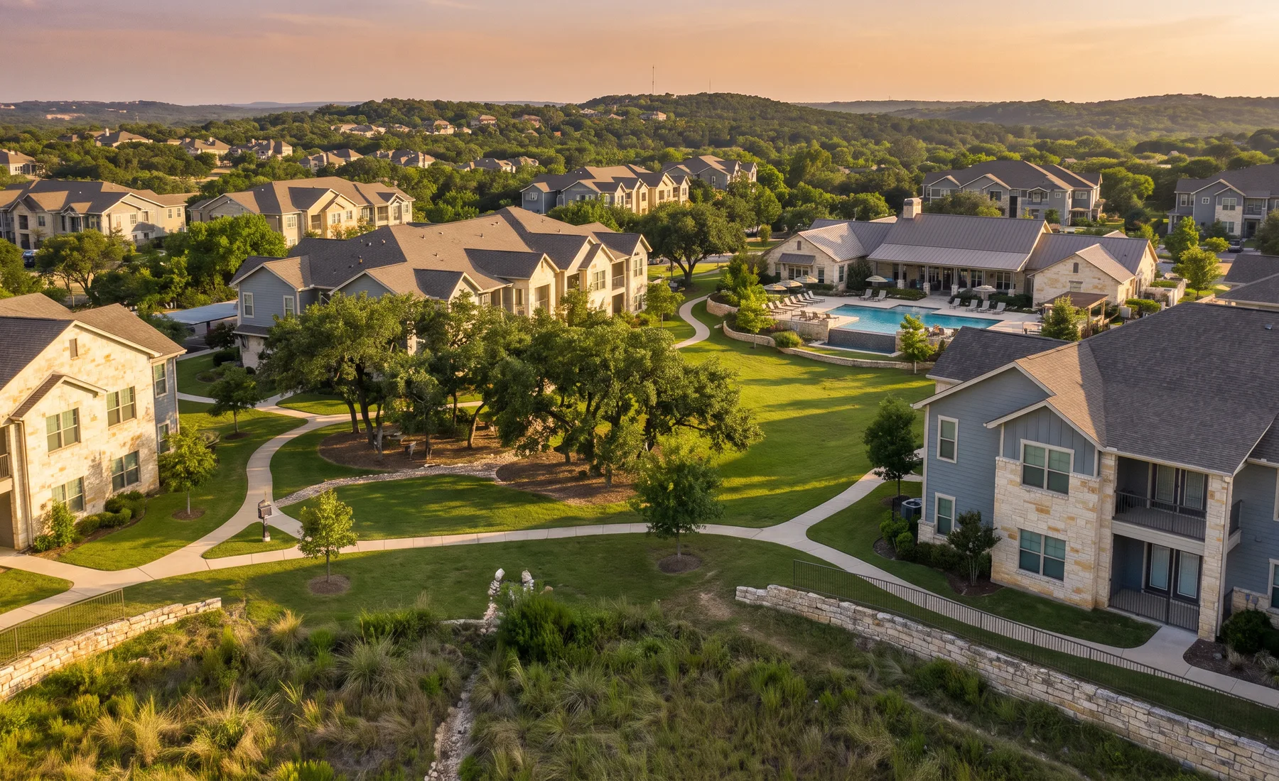 A broad landscaped garden-style multifamily community vista, shown as representative imagery.